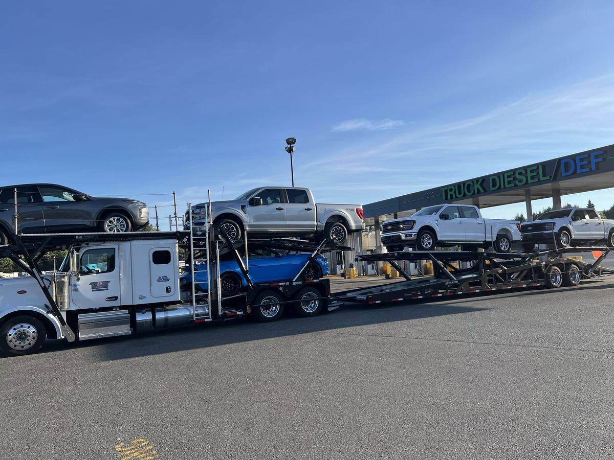 TES Transportation hauler carrying new pickup trucks