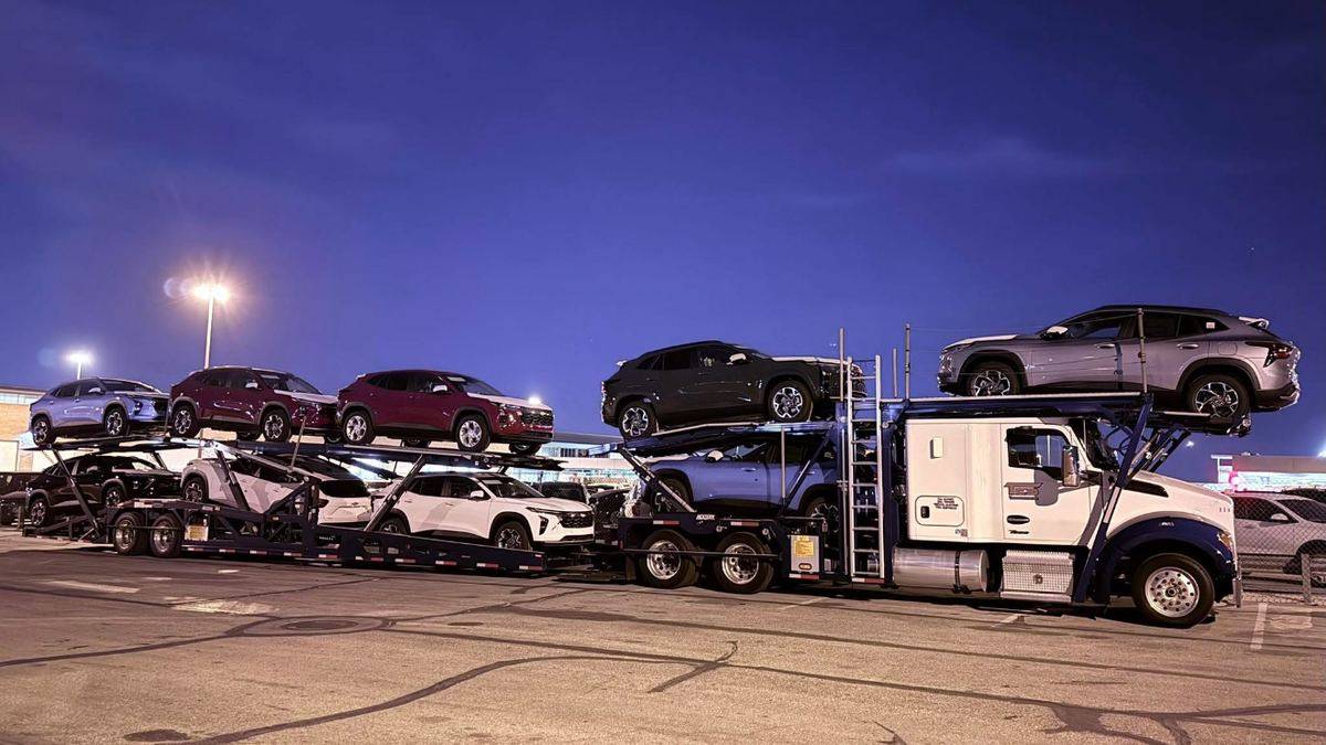 TES car hauler loaded with new SUVs at night
