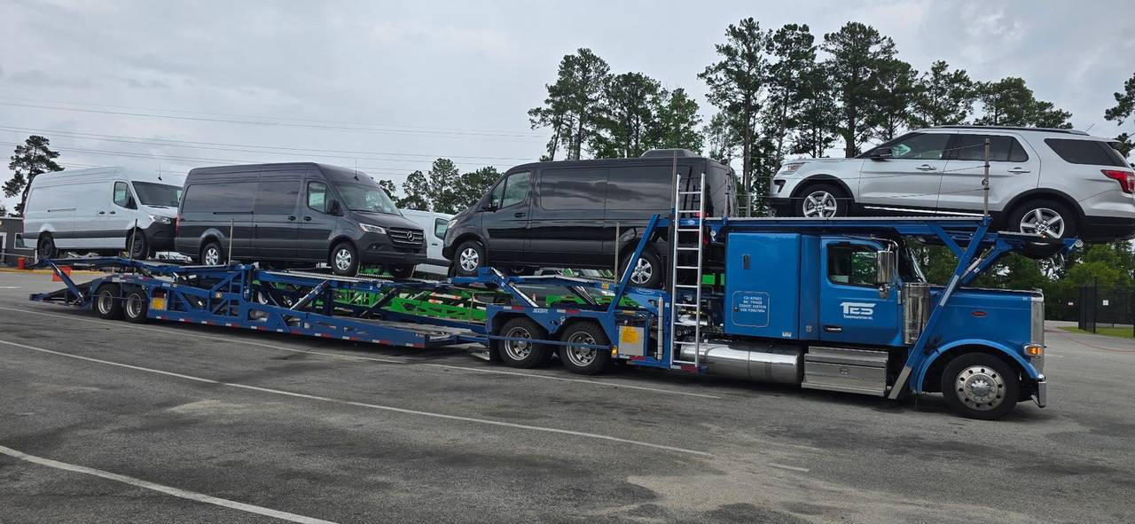 TES Transportation truck showing USDOT 2187528 with cargo vans